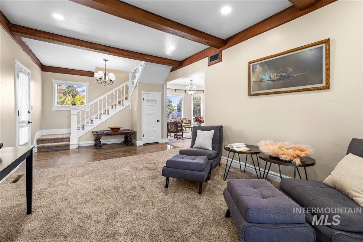 5611 West Hill Road Boise, ID 83703 - Photo 6 of 48 Living area with a chandelier, stairway, beam ceiling, dark wood-style finished floors, and recessed lighting