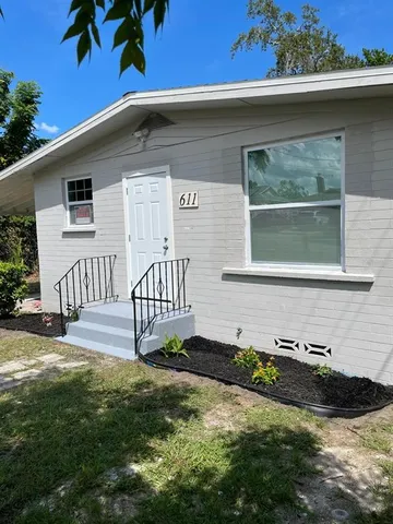 a front view of a house with garden