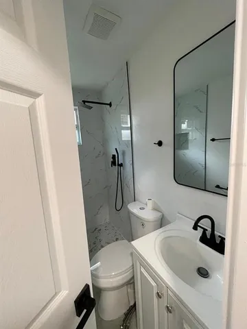 a bathroom with a sink toilet and shower