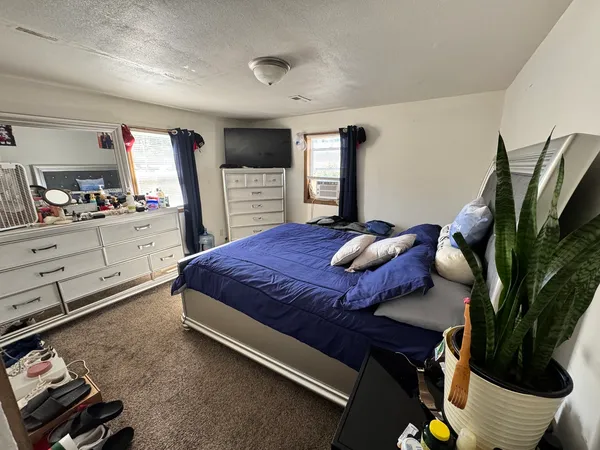 a bedroom with a bed and a flat screen tv