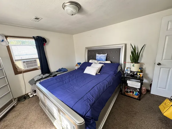 a bed room with a bed and a window