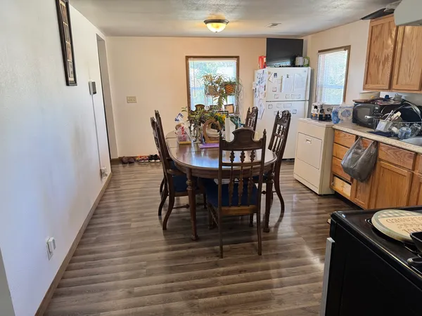 a view of a dining room with furniture and wooden floor