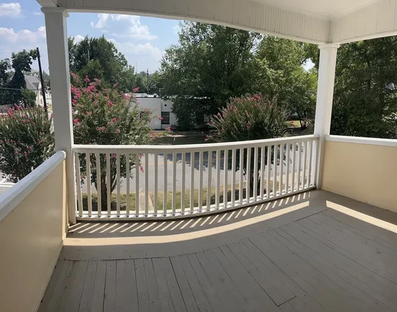 a view of balcony with wooden floor