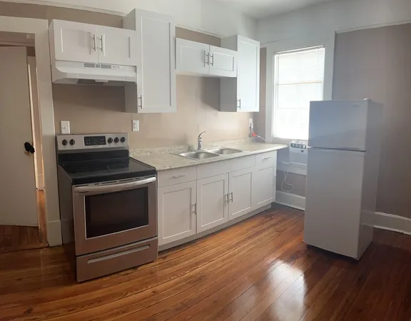 a kitchen with stainless steel appliances a stove a sink and a refrigerator