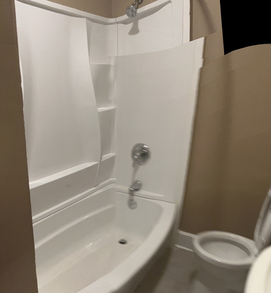 1231 18th Street, Unit C Columbus, GA 31901 - Photo 7 of 12 a white bath tub sitting next to a white toilet