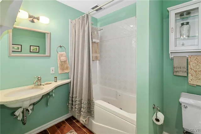 a bathroom with a sink a mirror and a shower