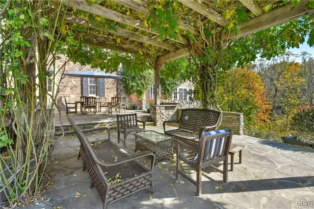 a view of a house with swimming pool and sitting area