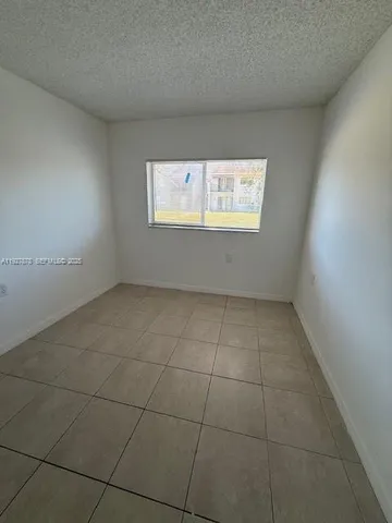 an empty room with a empty space and a window