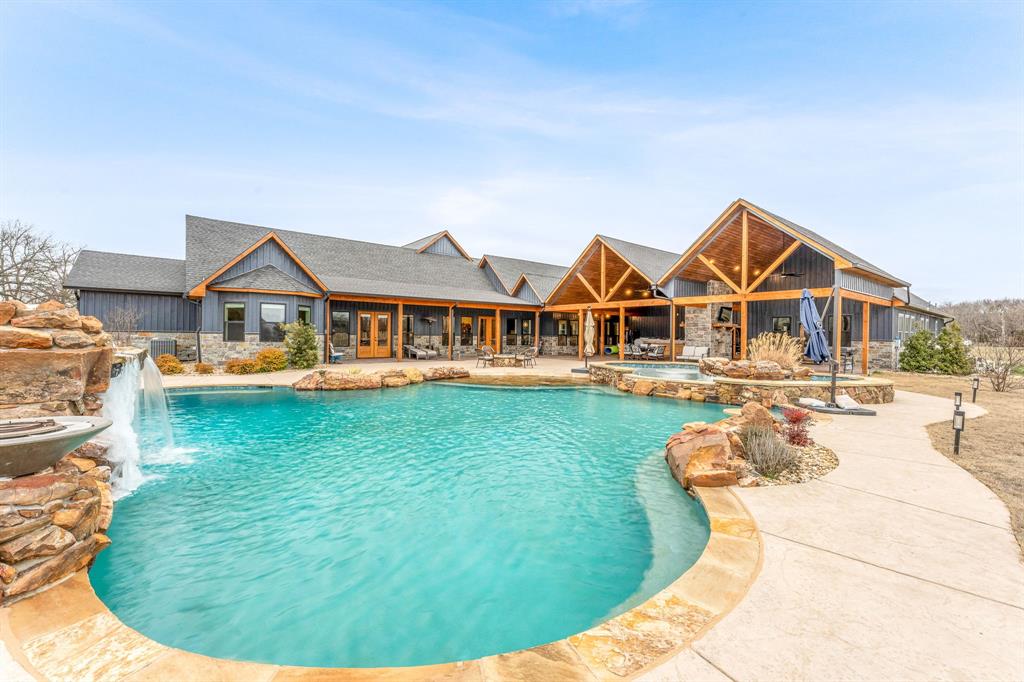 239 32507th Road Paris, TX 75460 - Photo 23 of 40 View of pool featuring a patio area and a pool with connected hot tub
