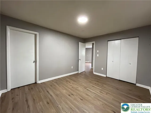 a view of an empty room with wooden floor