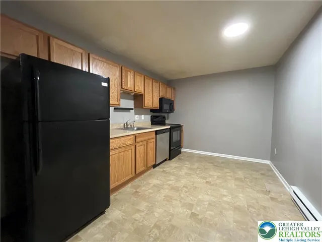 a kitchen with a refrigerator and a sink