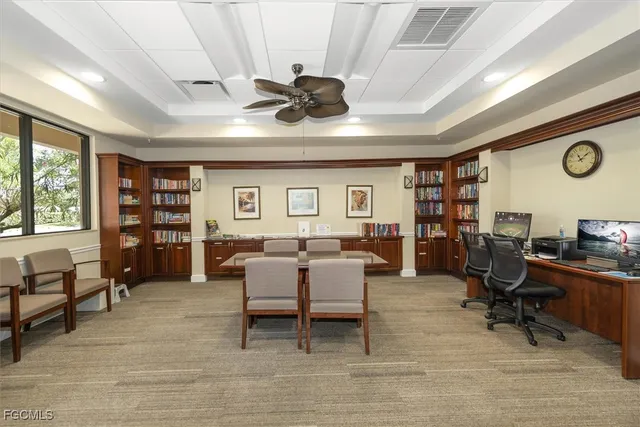 a view of a livingroom with workspace and a window