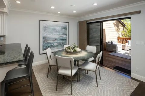 a dining room with furniture and wooden floor