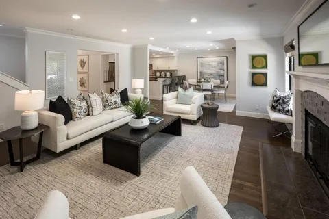 a living room with fireplace furniture and a wooden floor