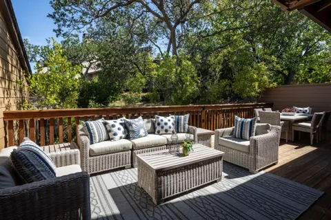 a roof deck with couches and potted plant