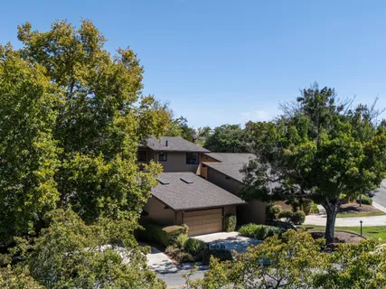 a view of a house with a yard and hanging chair