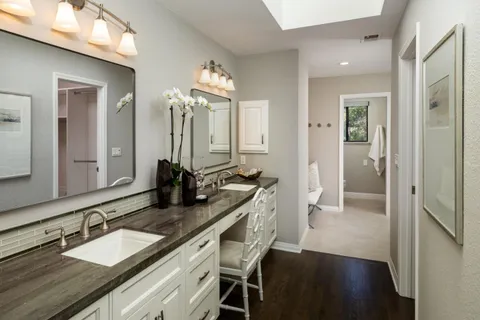 a bathroom with a sink double vanity granite tub and shower