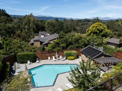 an aerial view of a houses with a yard