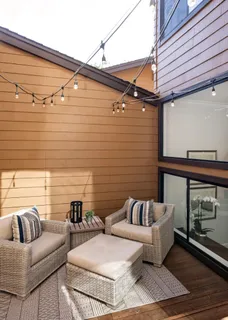 a view of a patio with couches and a fireplace