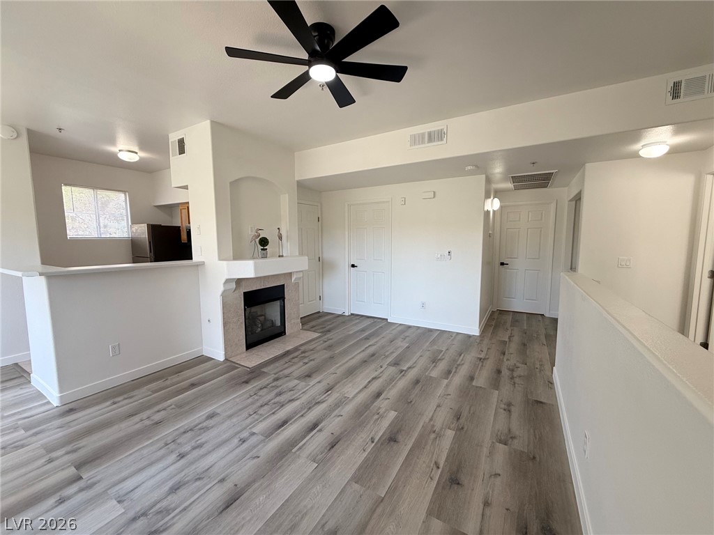 9050 West Warm Springs Road, Unit 2002 Las Vegas, NV 89148 - Photo 7 of 46 This bright living area features sleek flooring, a modern fireplace, and an open layout.