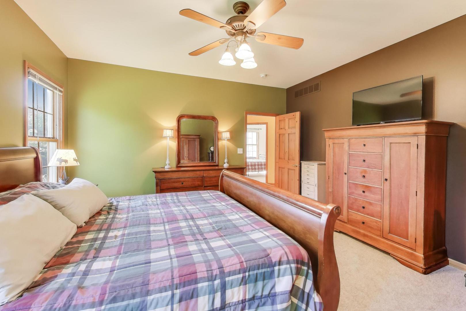 9206 Pine Needle Pass Bull Valley, IL 60097 - Photo 13 of 44 a bedroom with a bed and wooden floor