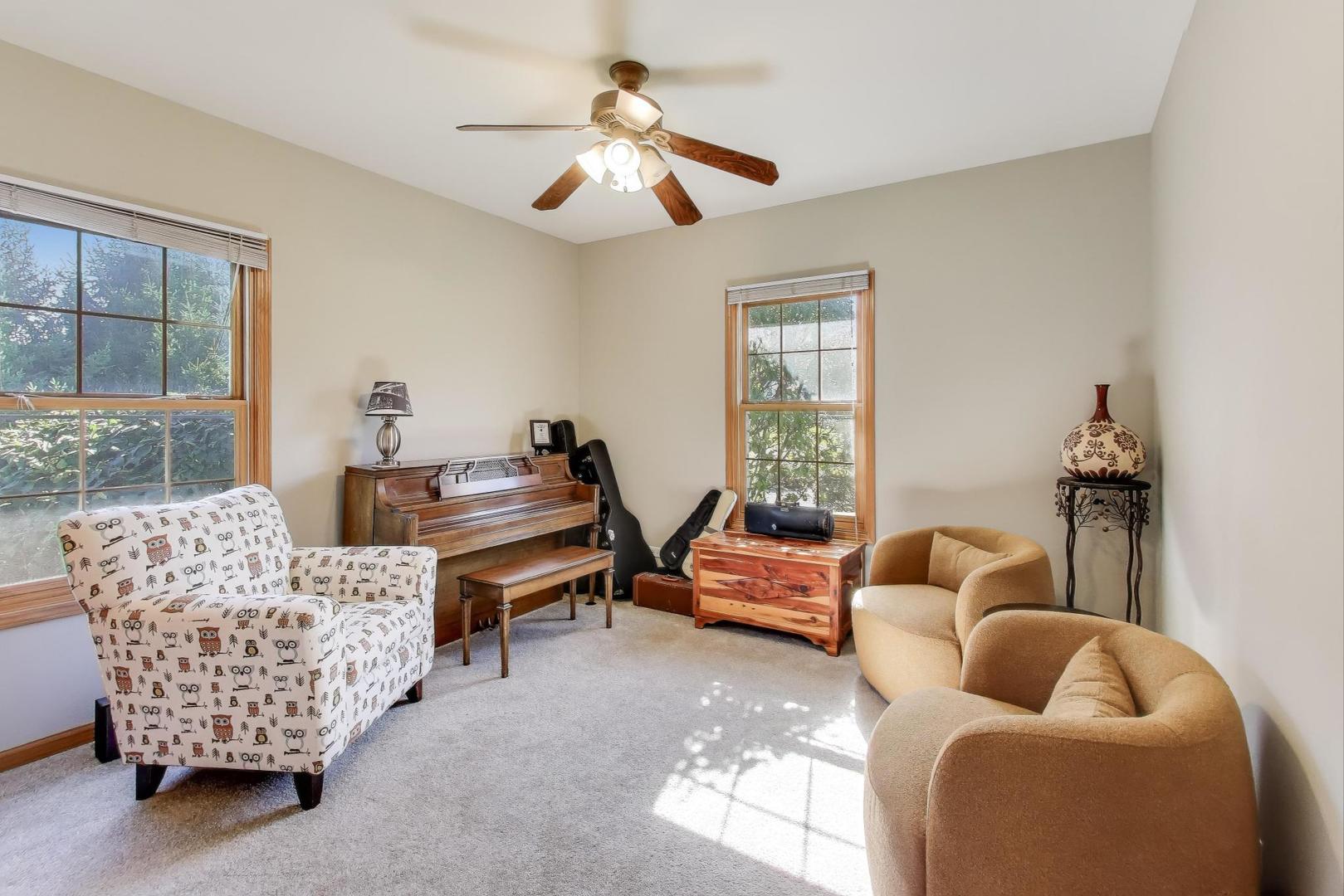 9206 Pine Needle Pass Bull Valley, IL 60097 - Photo 17 of 44 a living room with furniture and a large window