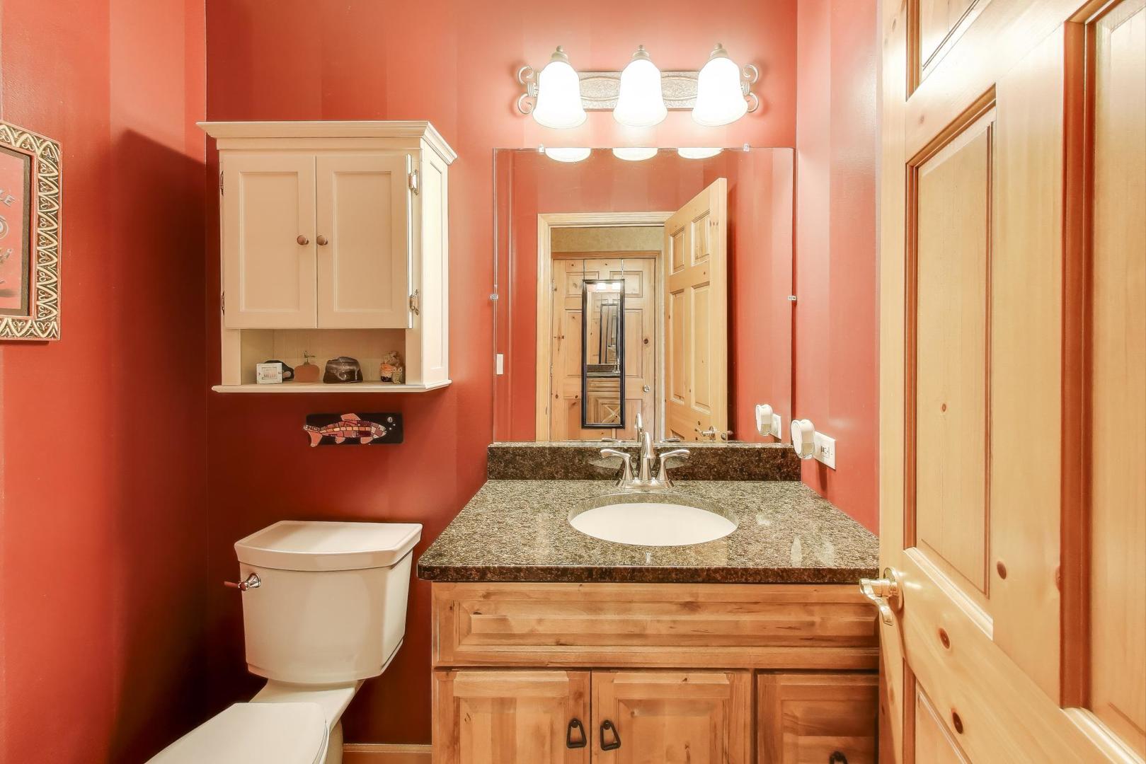 9206 Pine Needle Pass Bull Valley, IL 60097 - Photo 19 of 44 a bathroom with a granite countertop sink and a mirror