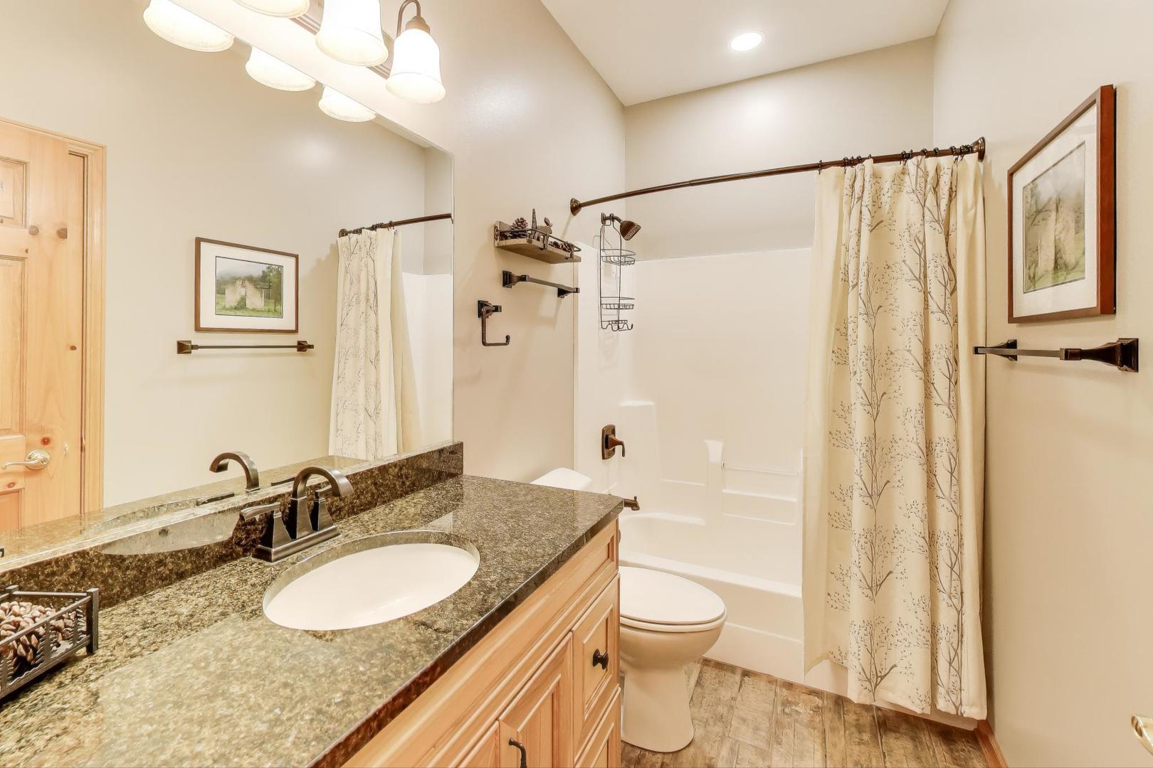 9206 Pine Needle Pass Bull Valley, IL 60097 - Photo 20 of 44 a bathroom with a granite countertop sink a toilet and a shower