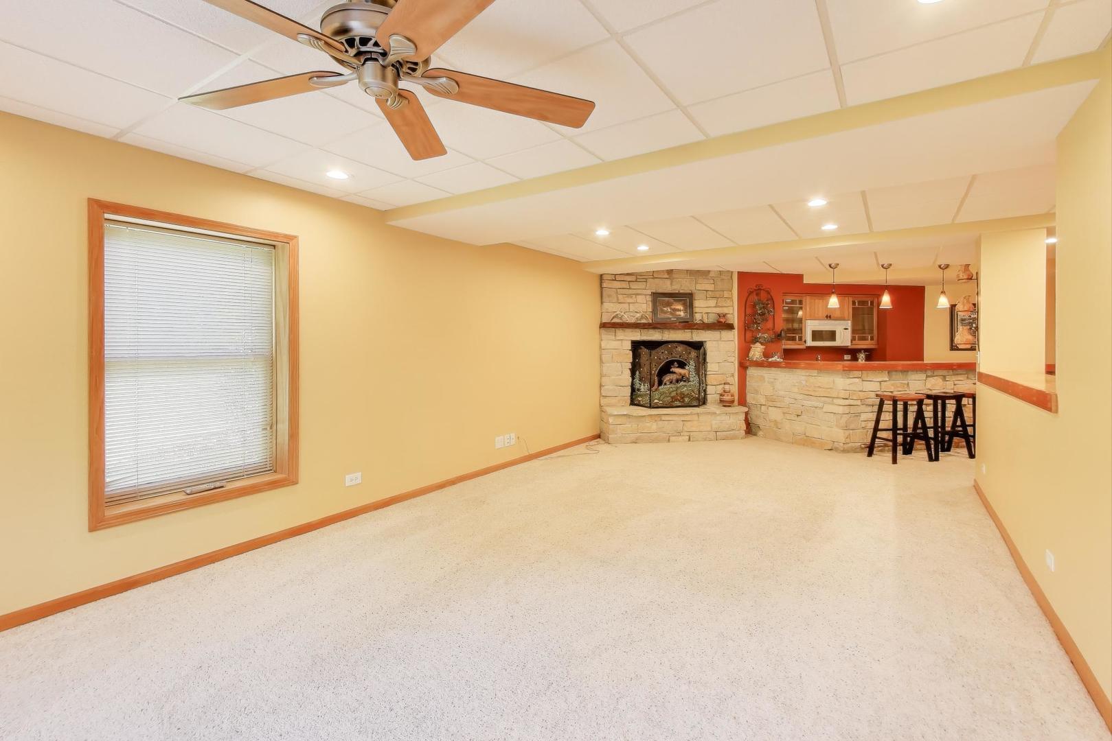 9206 Pine Needle Pass Bull Valley, IL 60097 - Photo 23 of 44 a view of a livingroom with a flat screen tv