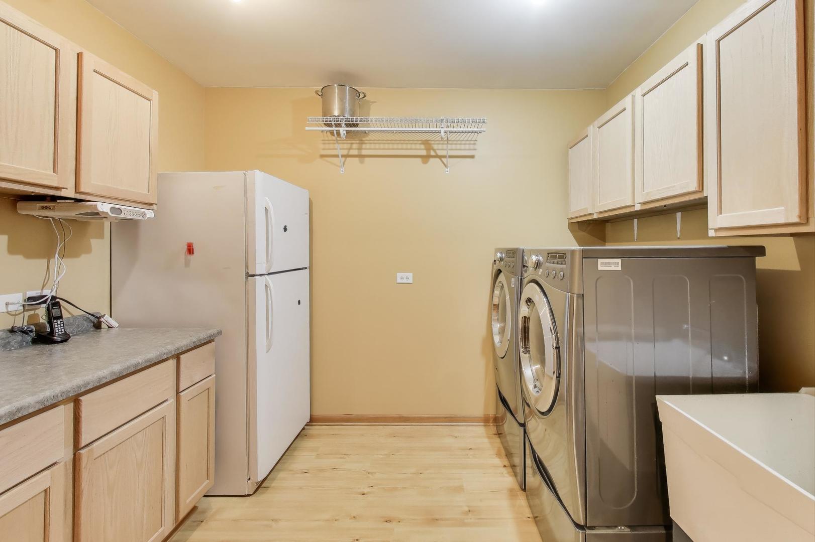 9206 Pine Needle Pass Bull Valley, IL 60097 - Photo 30 of 44 a utility room with cabinets washer and dryer