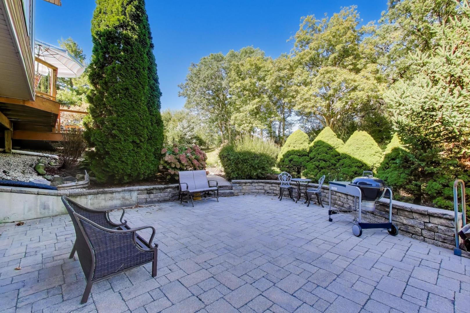 9206 Pine Needle Pass Bull Valley, IL 60097 - Photo 33 of 44 a view of a backyard with sitting area and furniture