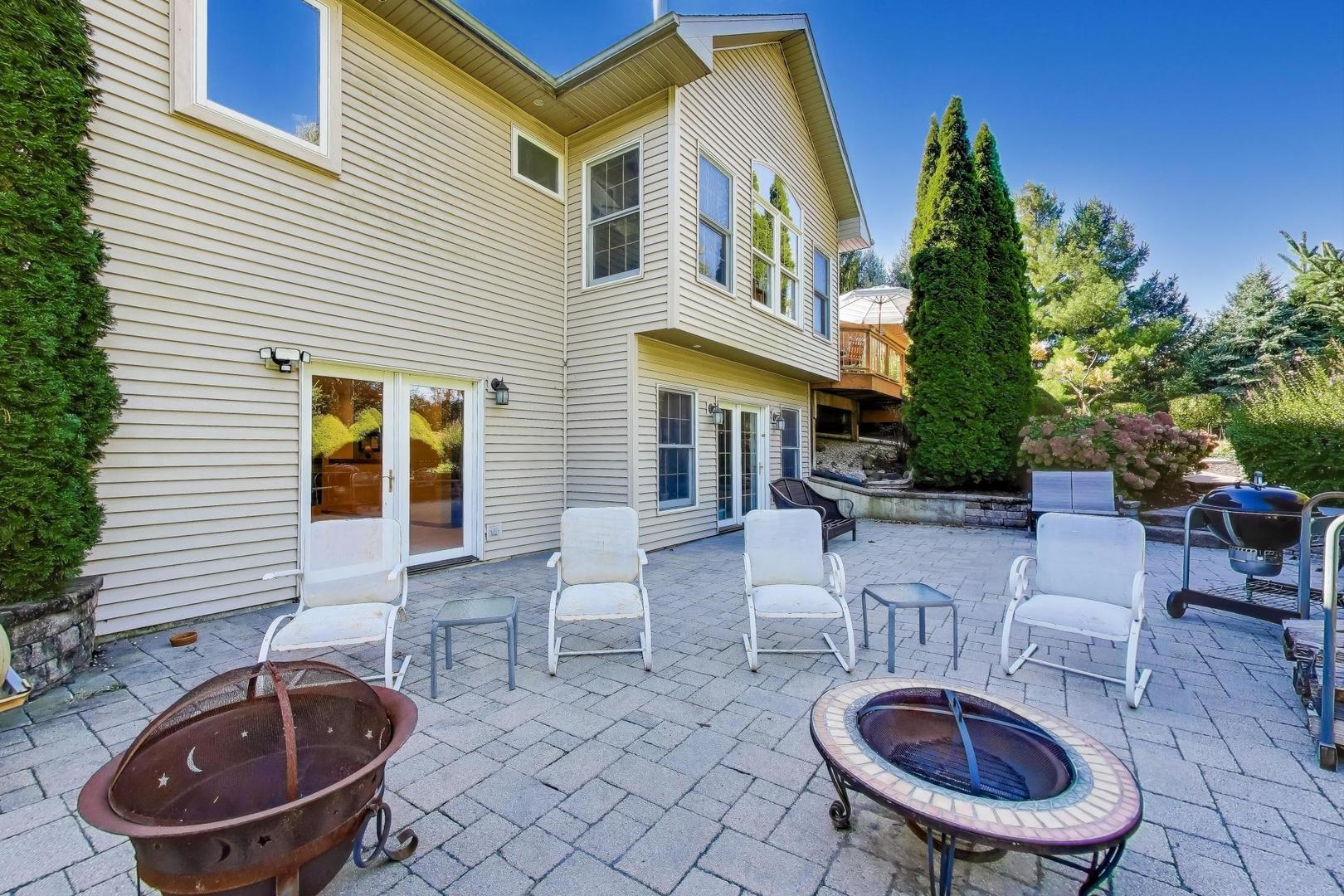 9206 Pine Needle Pass Bull Valley, IL 60097 - Photo 34 of 44 a view of house with backyard and furniture