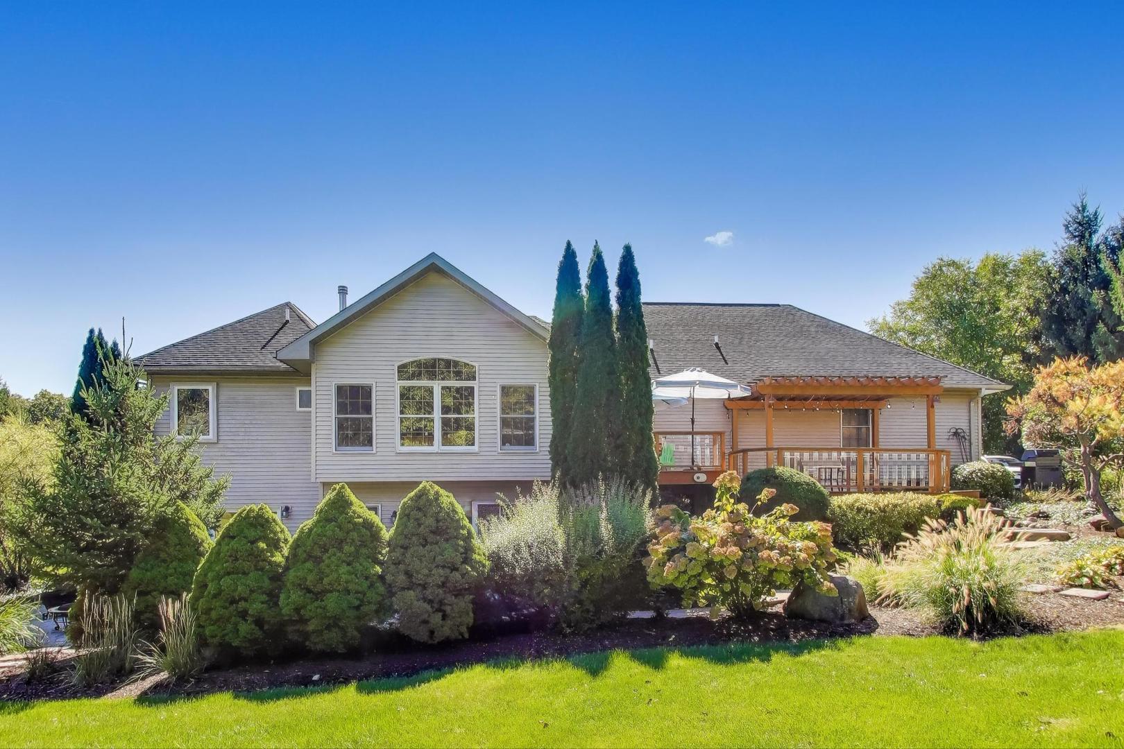 9206 Pine Needle Pass Bull Valley, IL 60097 - Photo 35 of 44 a front view of a house with garden
