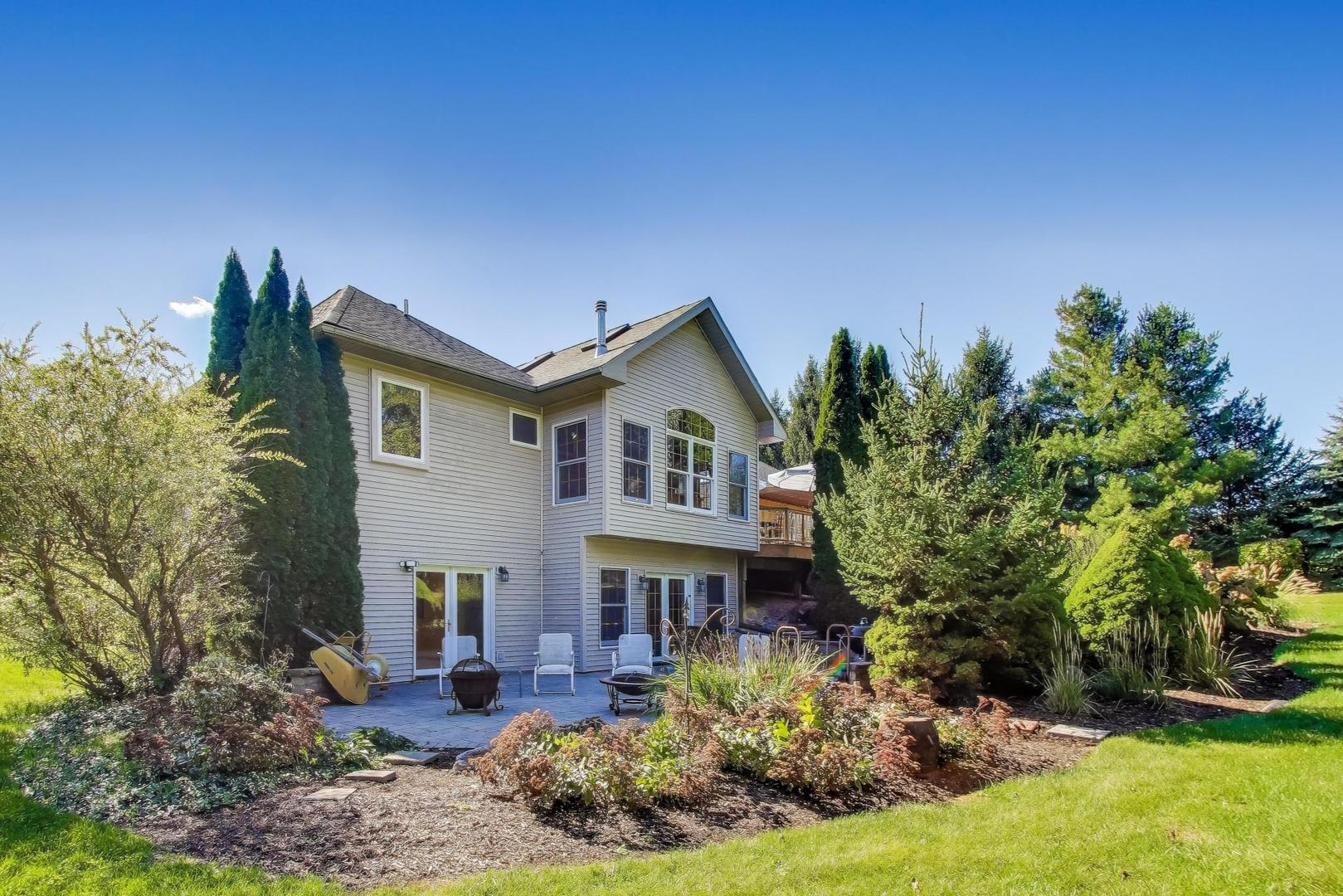9206 Pine Needle Pass Bull Valley, IL 60097 - Photo 36 of 44 a front view of a house with a yard
