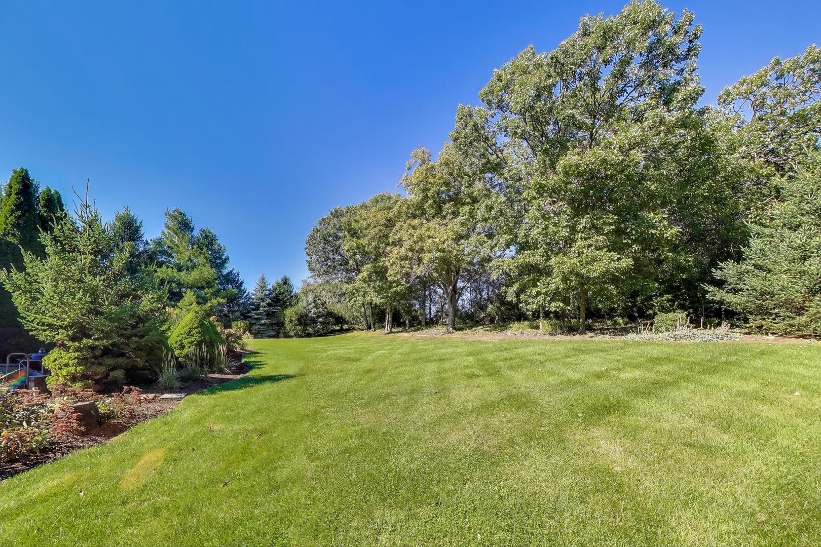 9206 Pine Needle Pass Bull Valley, IL 60097 - Photo 38 of 44 a view of field with trees in the background