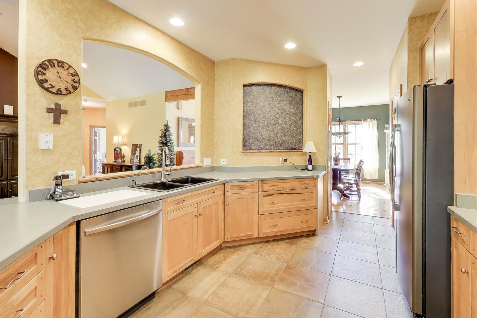 9206 Pine Needle Pass Bull Valley, IL 60097 - Photo 7 of 44 a large bathroom with a granite countertop sink a mirror a vanity and a bathtub