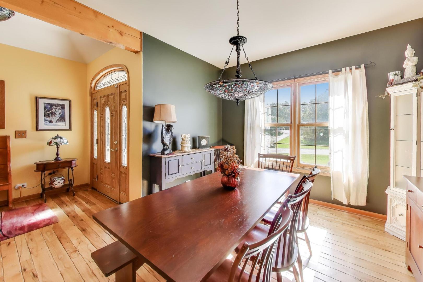 9206 Pine Needle Pass Bull Valley, IL 60097 - Photo 10 of 44 a view of a dining room with furniture window and wooden floor