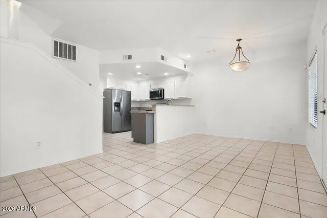 a kitchen with stainless steel appliances a refrigerator and microwave