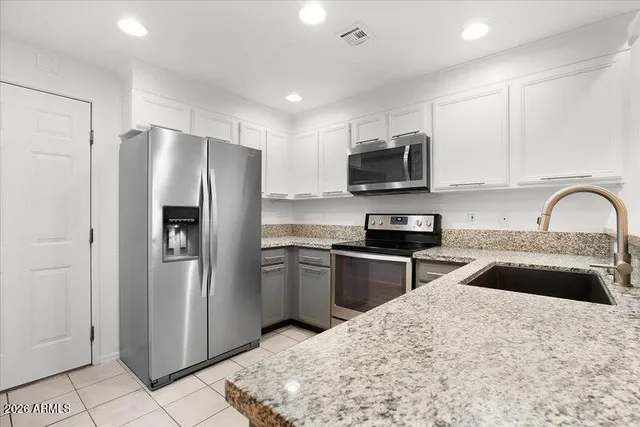 a kitchen with a refrigerator sink and microwave
