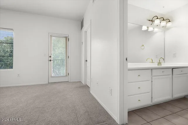 a bathroom with a double vanity sink and a mirror
