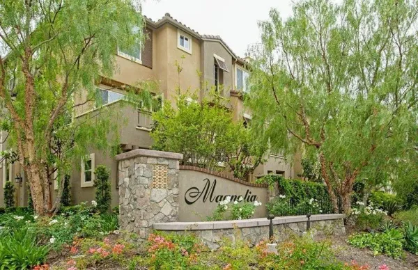 a view of a sign board with tall buildings