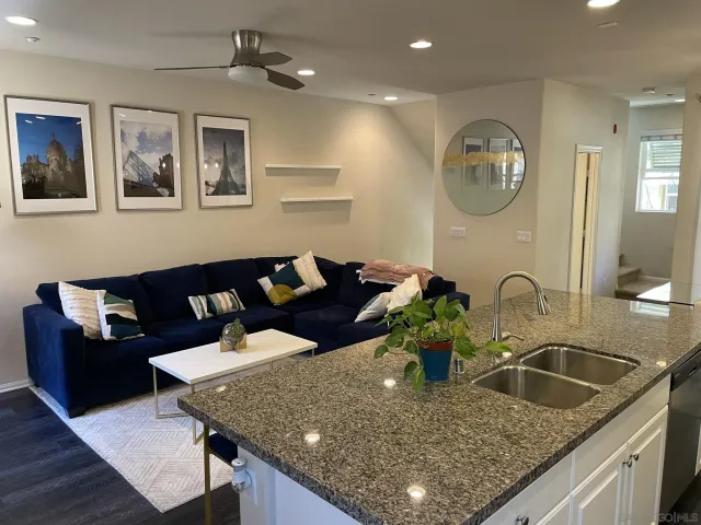 a kitchen with a stove a kitchen island a dining table and chairs