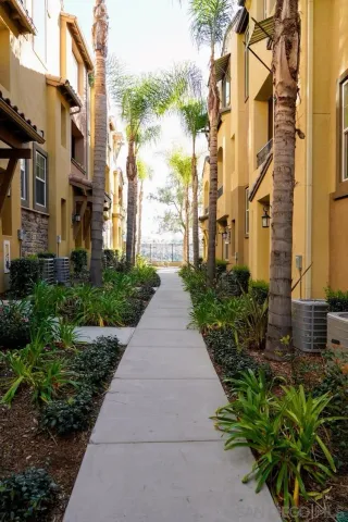 a view of a pathway both side of the house