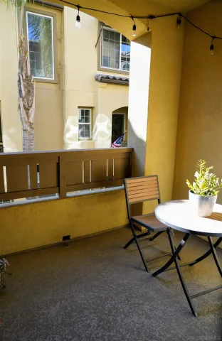 a balcony with table and chairs