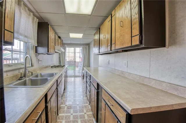 a kitchen with a sink stove and cabinets