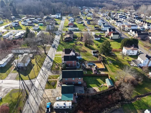 an aerial view of residential houses with outdoor space