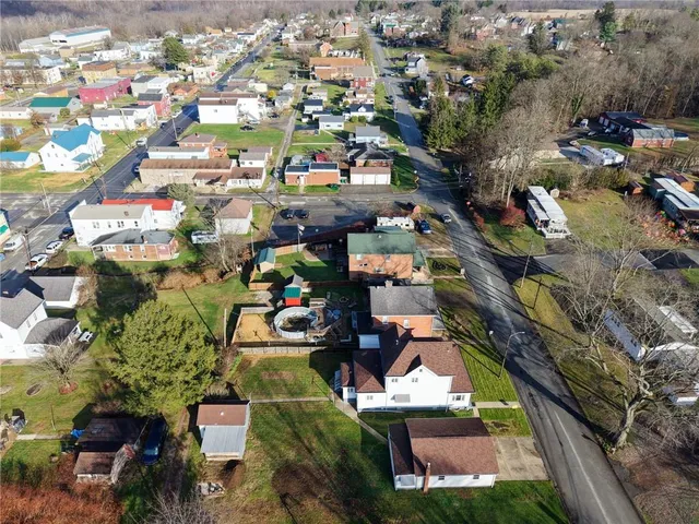 an aerial view of a houses with yard
