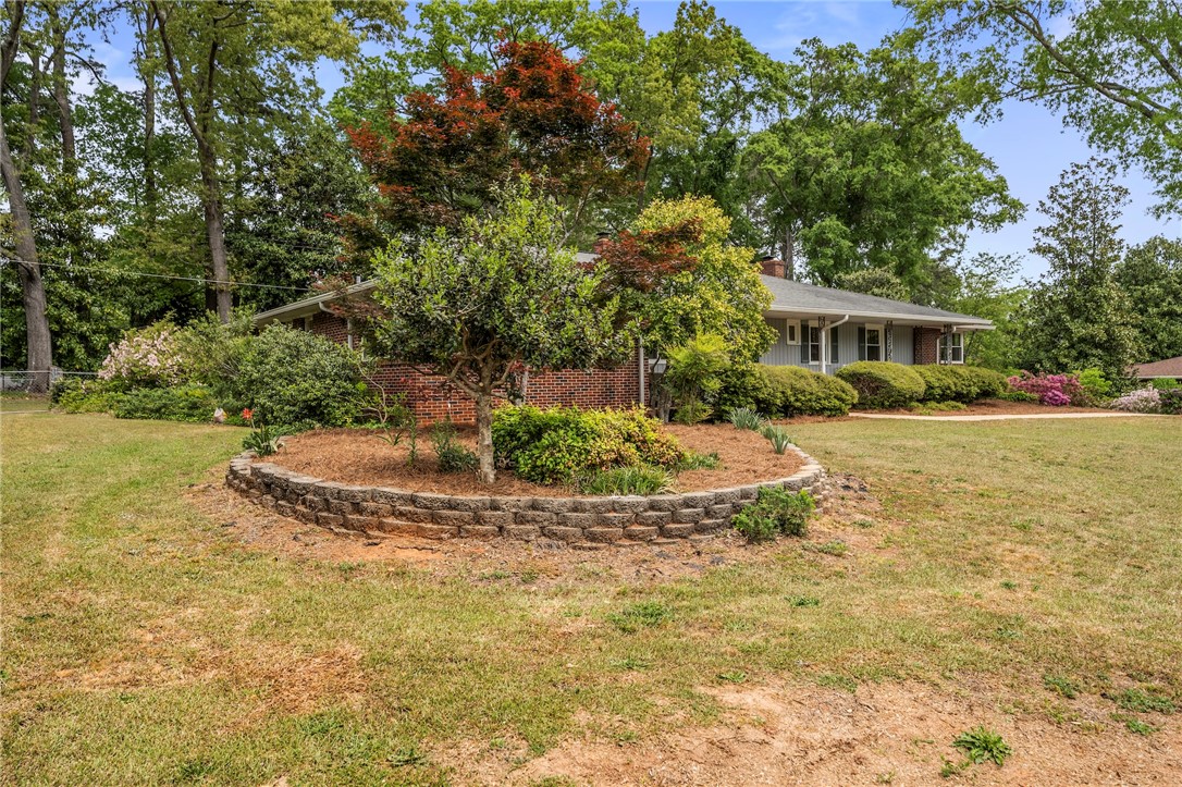 1105 Greenacres Anderson, SC 29621 - Photo 45 of 46 Mature trees frame this charming residence, boasting verdant landscaping and inviting curb appeal.