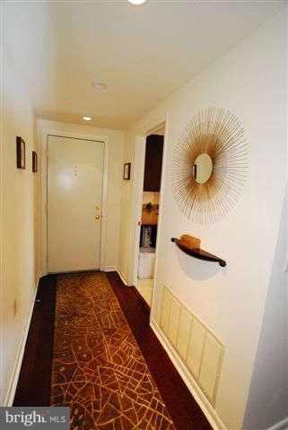 120 Cross Keys Road, Unit R120F Baltimore, MD 21210 - Photo 2 of 17 a bedroom with a bed and a chandelier