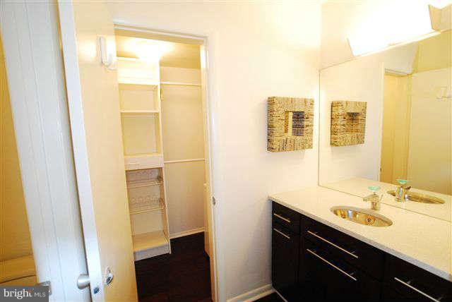 120 Cross Keys Road, Unit R120F Baltimore, MD 21210 - Photo 13 of 17 a bathroom with a sink and a mirror